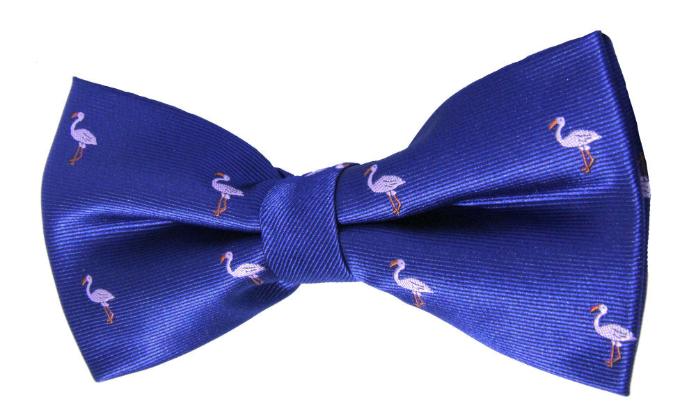 A vibrant blue Pink Flamingo Bow Tie featuring a playful pattern of small white flamingos evenly spaced across the fabric.