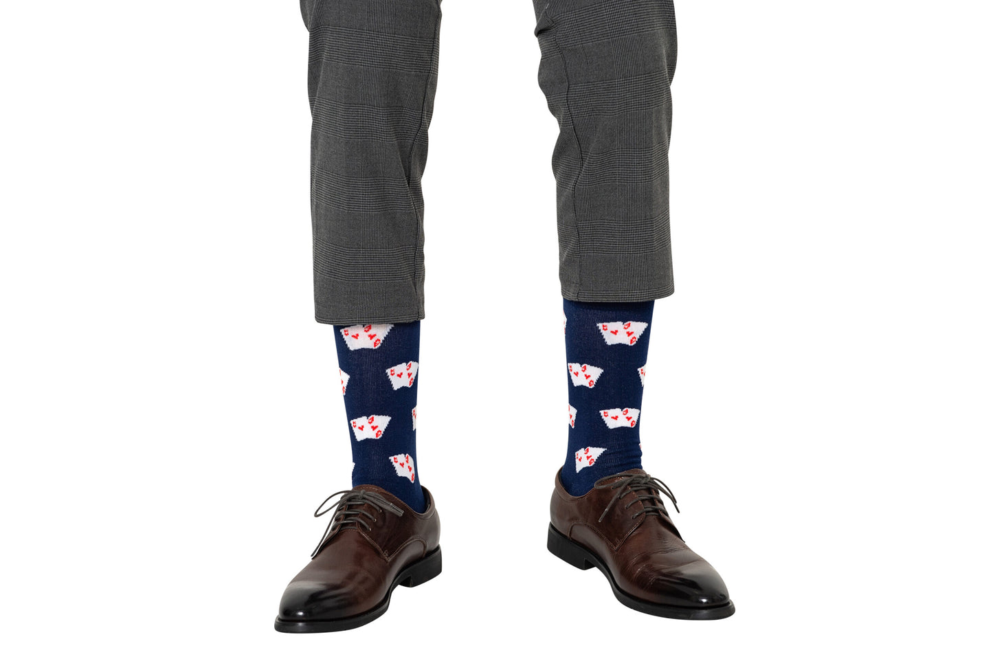 A person in gray dress pants and brown shoes sports Poker Socks, featuring a red and white playing card print—perfect for poker enthusiasts.