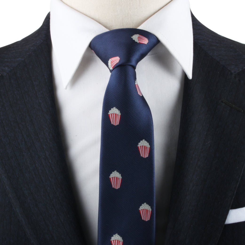 A close-up of a person wearing a dark pinstripe suit and a white dress shirt, with a Popcorn Tie—a true cinematic statement of style.