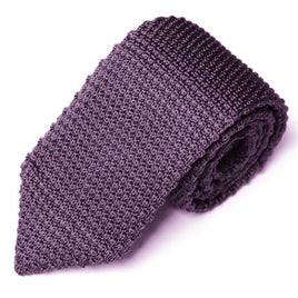 A rolled-up Classic Purple Knit Tie with modern flair on a white background.