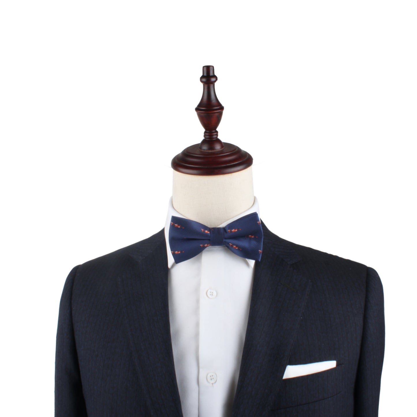 A mannequin dressed in a dark suit, white shirt, and Racing Car Bow Tie with a white pocket square exudes style against a plain white background.