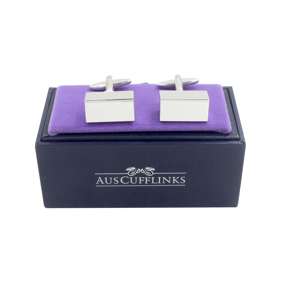 The Rectangle Prism Cufflinks, exuding timeless sophistication, are silver and rest on a purple felt tray inside a dark box labeled "AUSCufflinks.