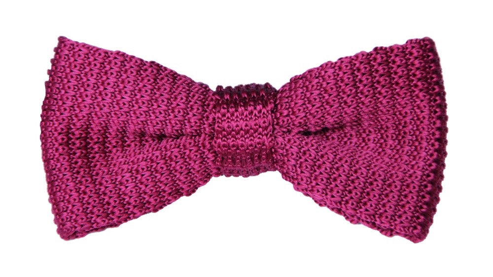 A versatile statement piece, the red knit bow tie crafted from textured fabric, is artfully displayed against a plain white background.