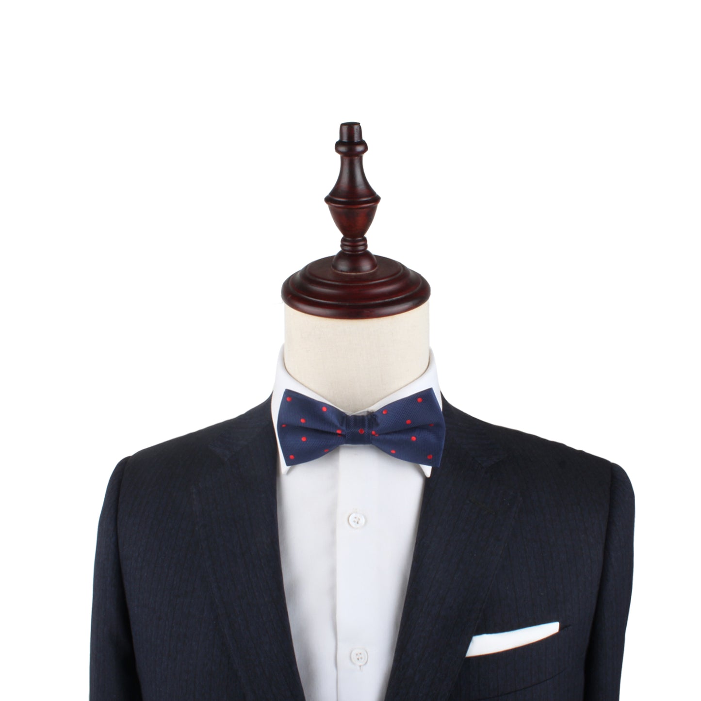 Mannequin dressed in a dark suit with a white shirt and our Red Polka Dot Bow Tie, set against a white background. This striking product description showcases a confident, fiery look.