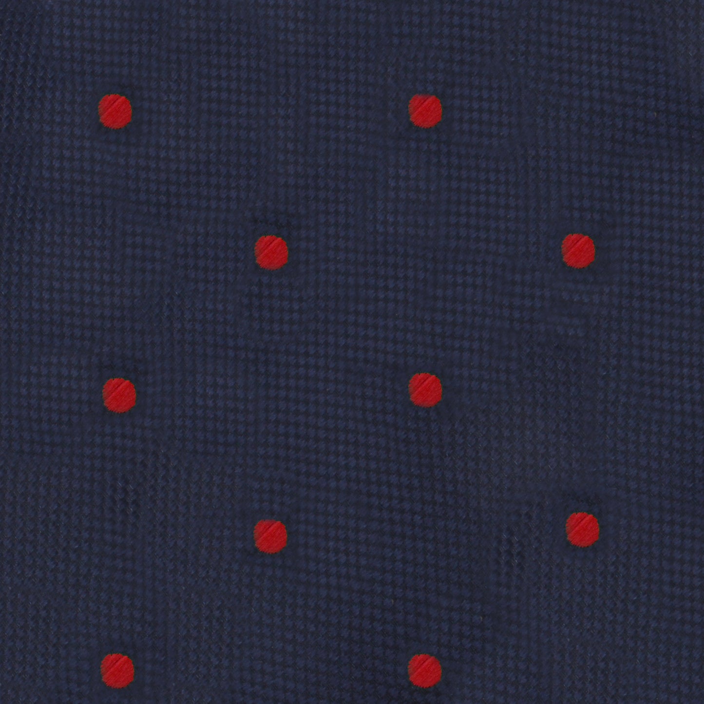 This product description showcases the Red Polka Dot Bow Tie, featuring a dark blue fabric adorned with bold dots and evenly spaced small red accents for a striking and fiery look.