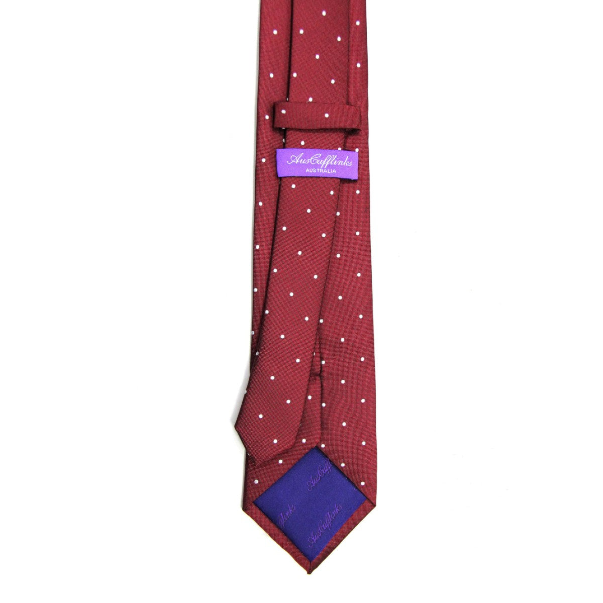 White Polka Dot Red Skinny Tie with a festive flair, featuring a purple label and blue lining, showcasing its stylish back side.