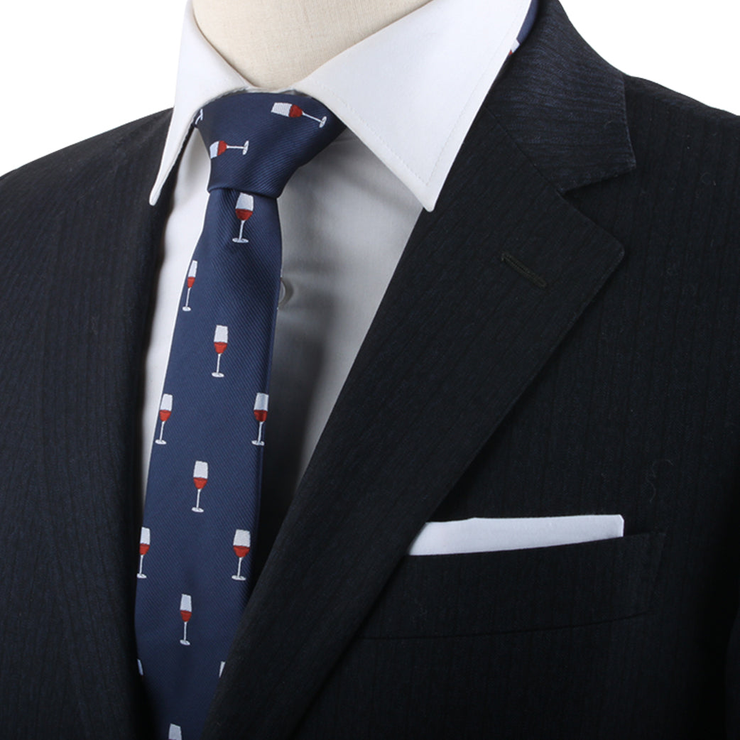 A person exudes modern charm in a black suit with a white shirt and the Wine Skinny Tie, featuring a pattern of red wine glasses, reflecting their refined taste.