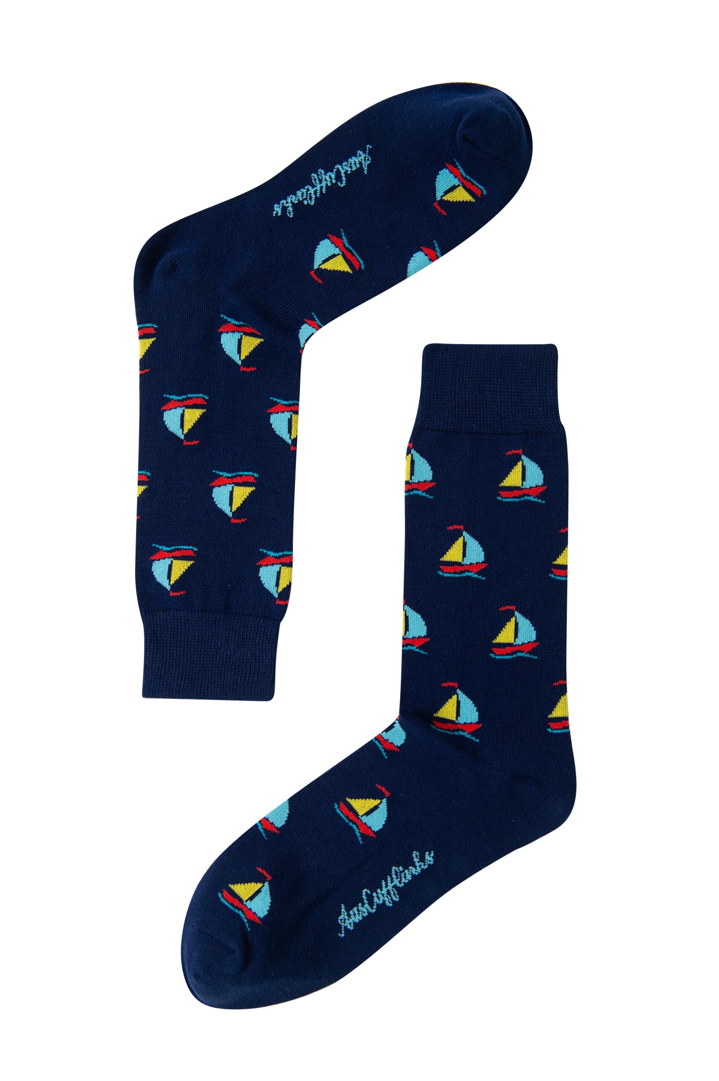 Sail Boat Socks: Navy blue nautical socks with a colorful sailboat pattern and “Audacious” in white on the soles—perfect for ocean lovers.