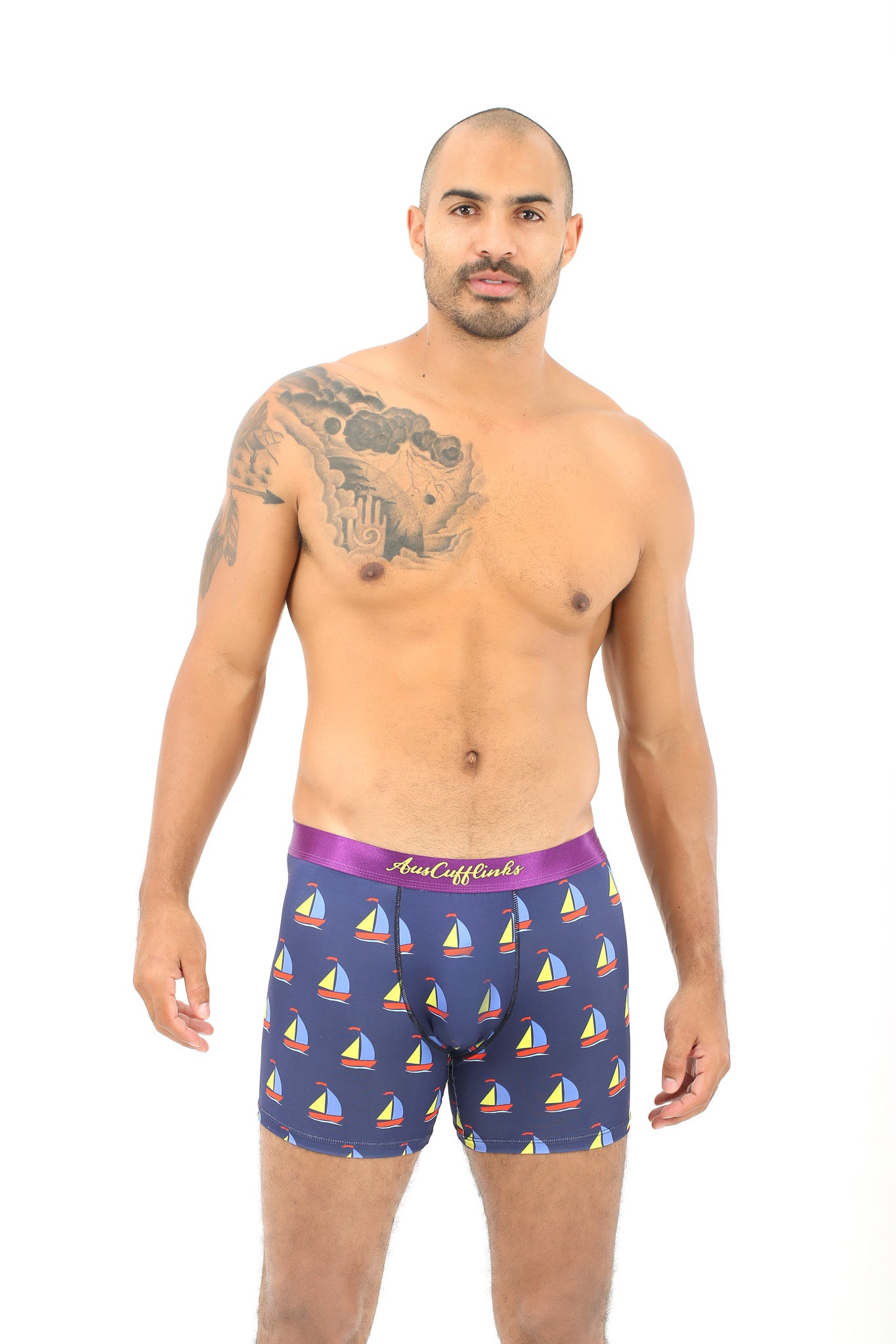 A man with a tattoo poses in Sail Boat Underwear, exuding a sense of coziness and adventure as he seems ready to navigate both life and waves.