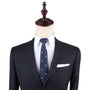 Displayed on a mannequin, a navy suit paired with a white dress shirt and the Seagul Slim Tie, which features small bird patterns, captures timeless style and lets one's confidence soar.