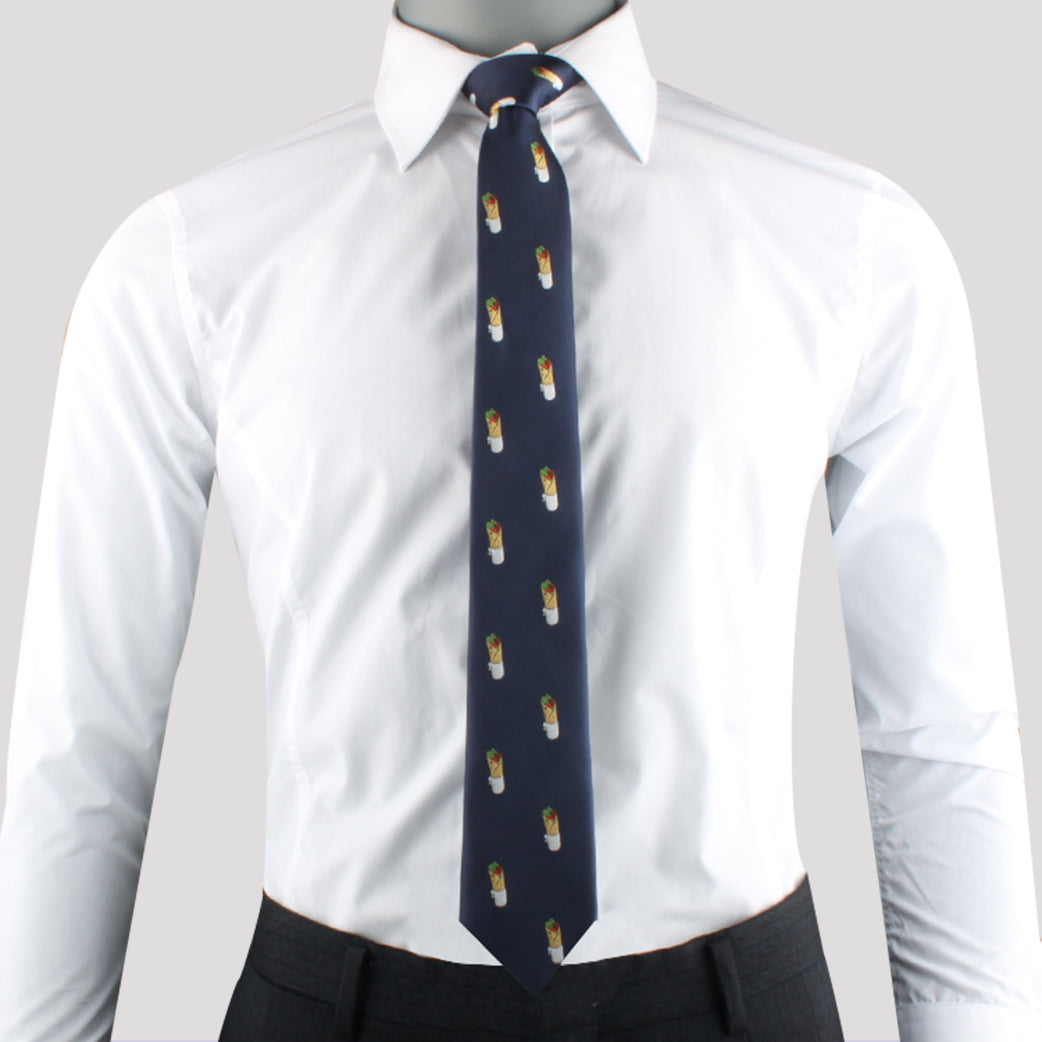 A person savoring the essence of style stands against a neutral background, wearing a white dress shirt and a Skewer Tie adorned with small, colorful patterns.