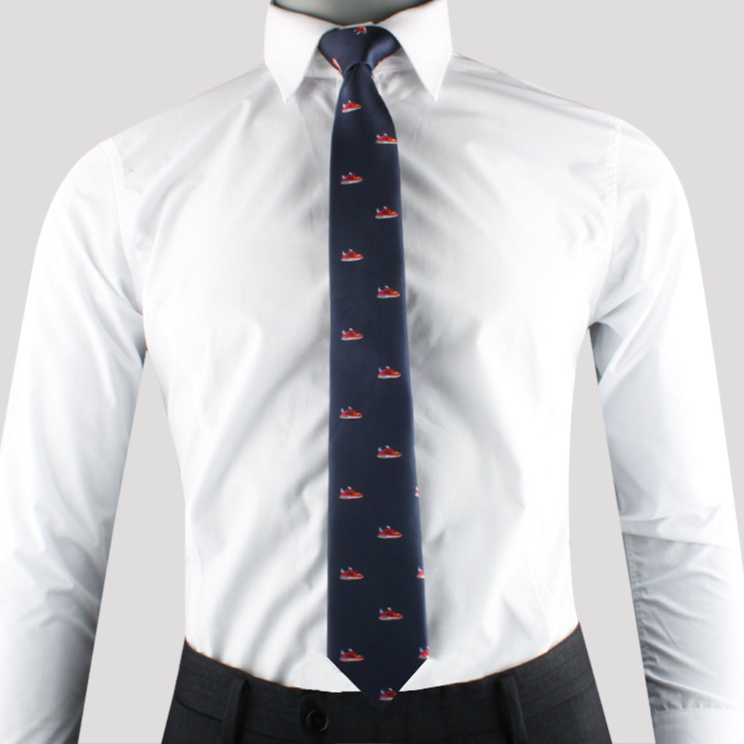 A person wearing a white dress shirt, dark trousers, and a Sneaker Print Tie exudes modern style.