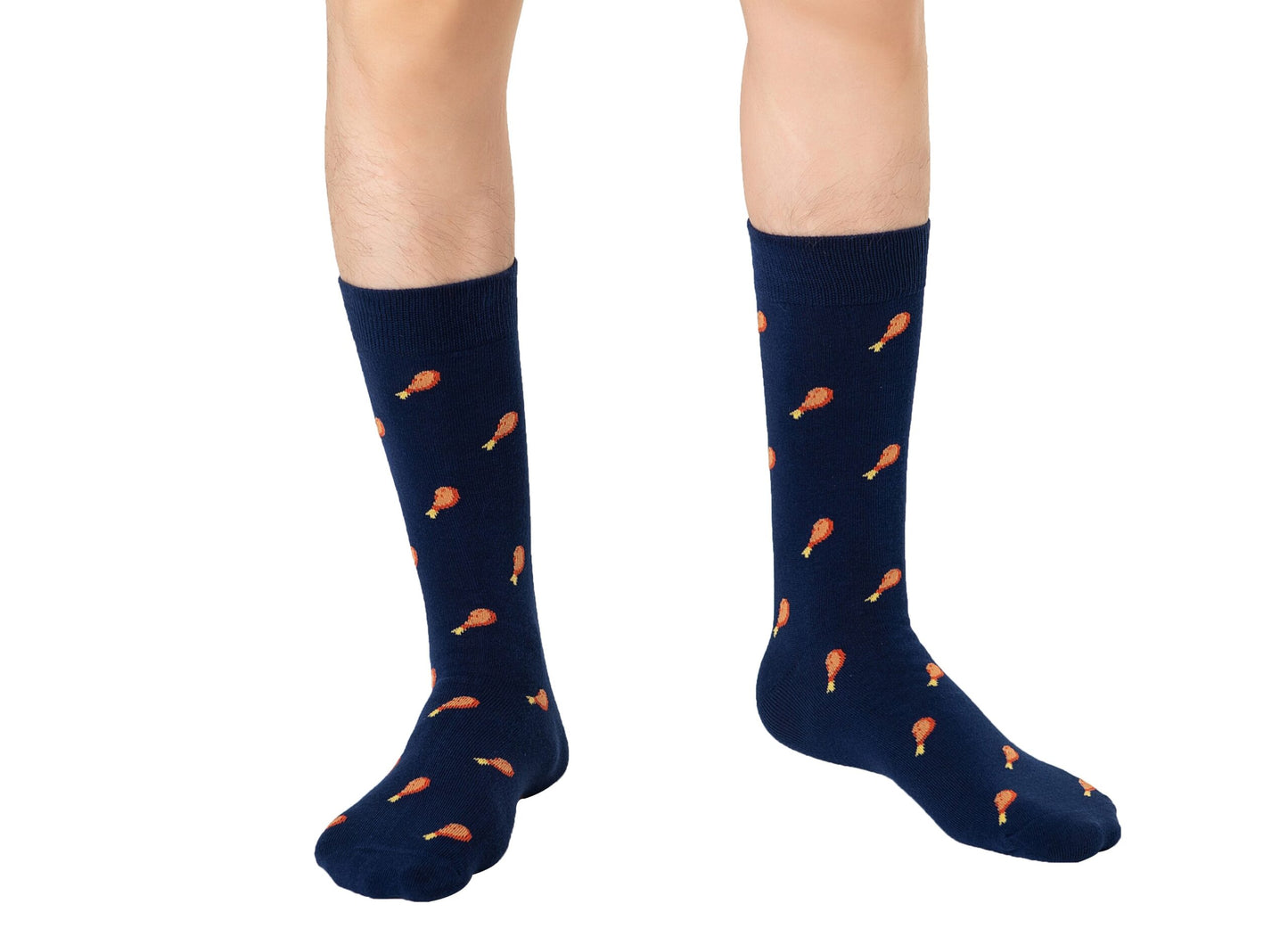 Person showcasing a layered style with knee-high navy Strawberry Cake Socks featuring an orange drumstick pattern.
