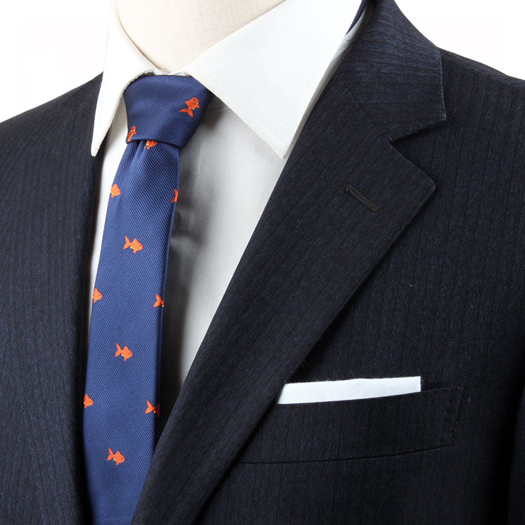 Close-up of a person wearing a dark suit with a white dress shirt and a Stylish Animal Tie. A white pocket square is visible in the suit's breast pocket, adding an extra touch of artistic charm.