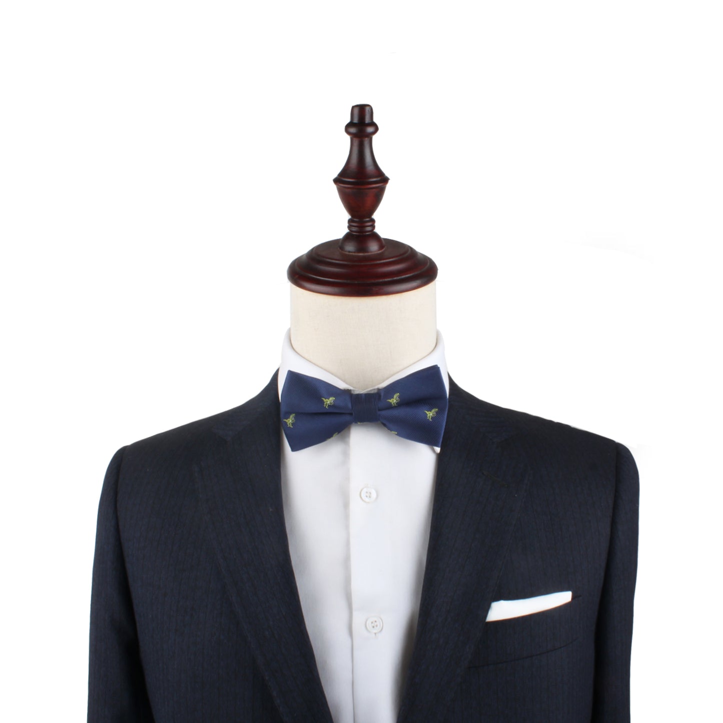 Wooden mannequin dressed in a dark suit with a white shirt, T-Rex Bow Tie, and a white pocket square exudes elegance reminiscent of a modern man.