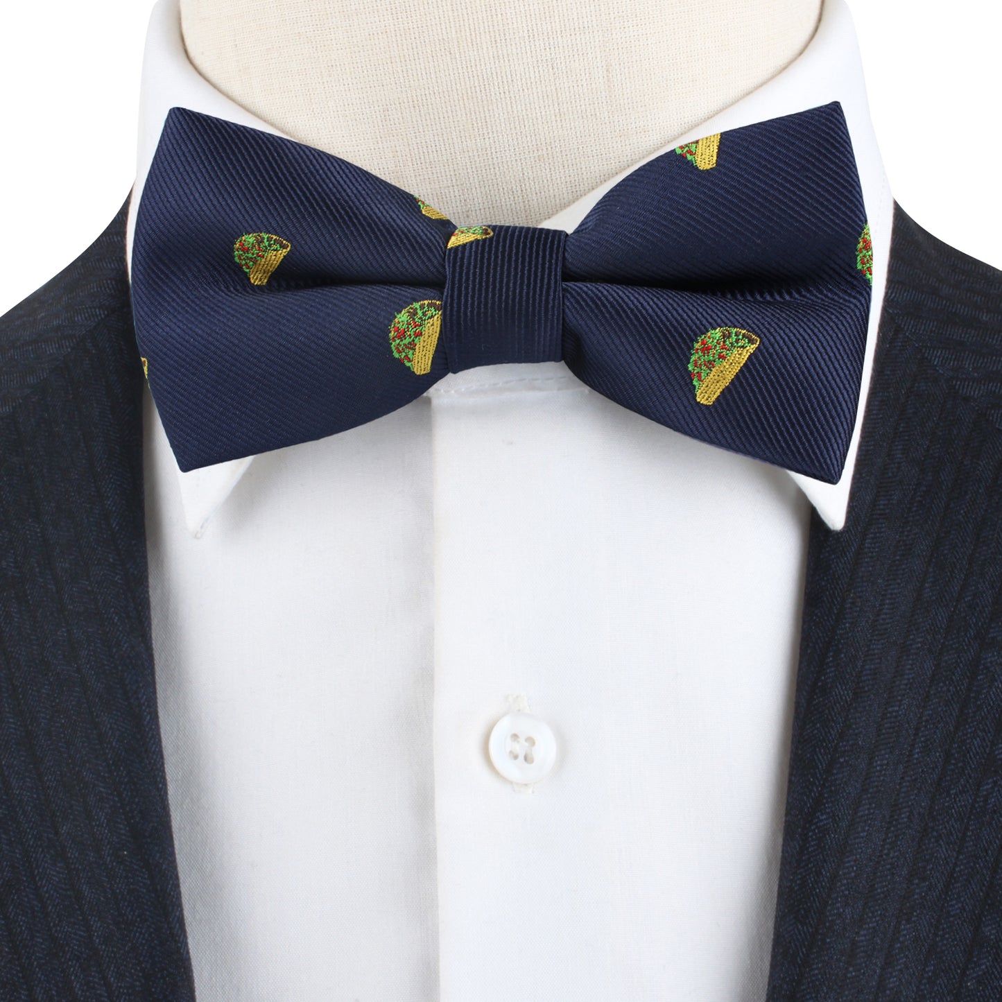 A Taco Bow Tie worn with a white dress shirt and a dark suit jacket.