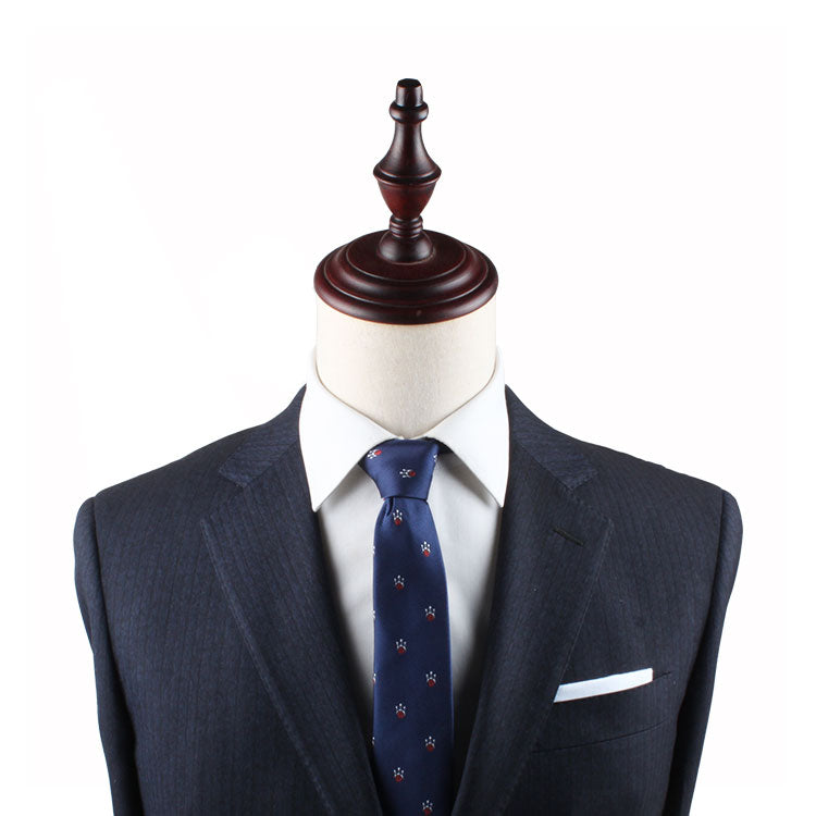 Mannequin dressed in a dark suit, white shirt, and the stylish Ten Pin Bowling Slim Tie, with a wooden top fixture, exuding effortless style.