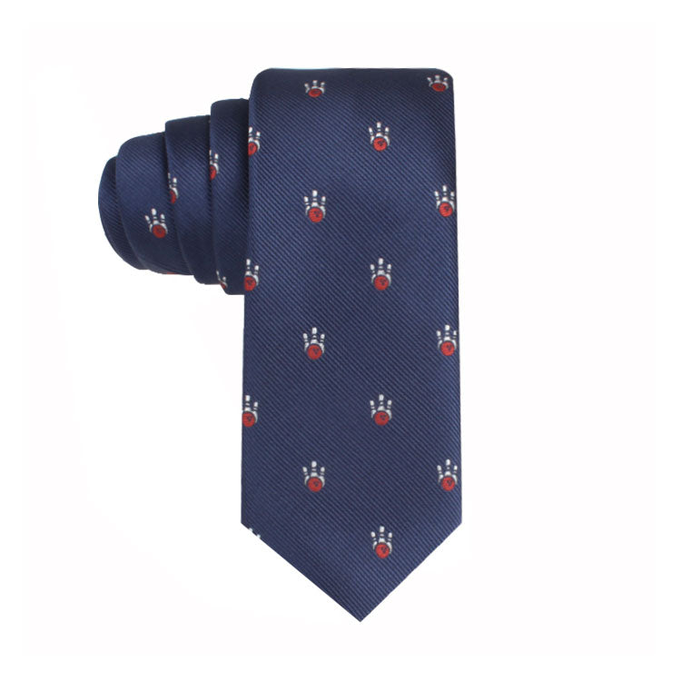The Ten Pin Bowling Thin Tie is a neatly rolled navy blue necktie adorned with a stylish pattern of red and white motifs scattered throughout, perfectly harmonizing classic aesthetics.