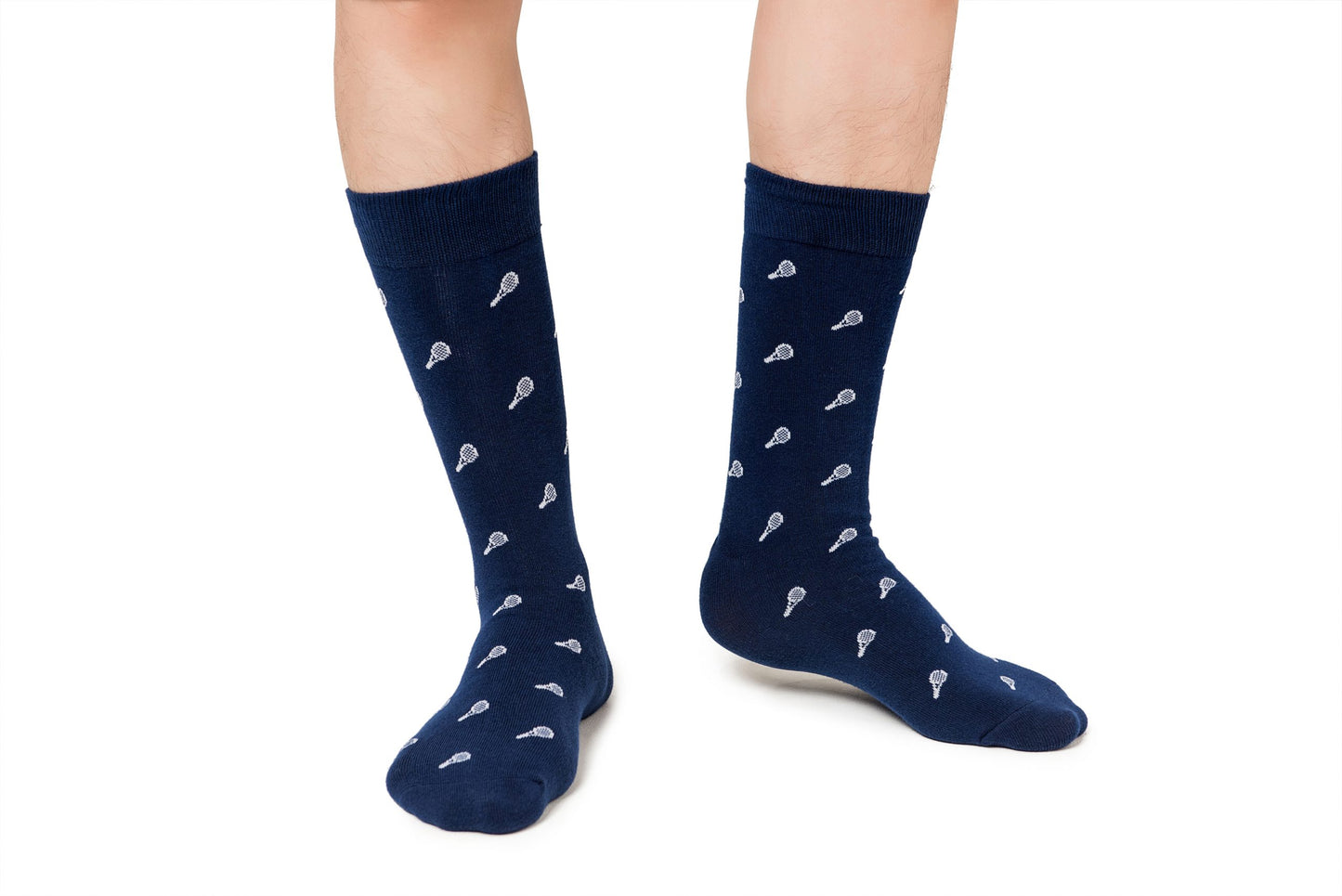 A pair of legs wearing navy blue Tennis Socks with white badminton racket patterns on a white background, designed for both performance and comfort.