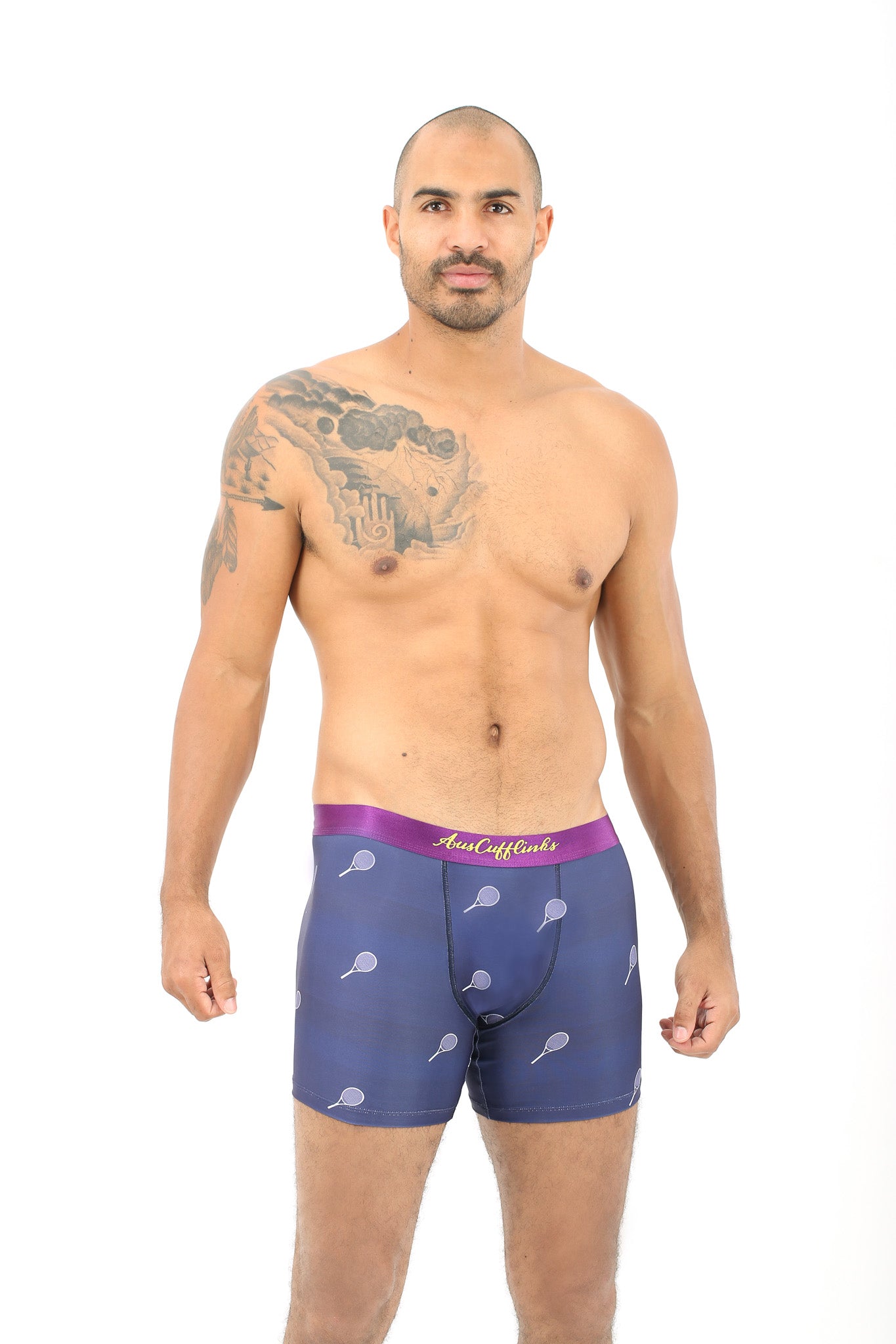 A man confidently models the Tennis Underwear in purple, featuring a playful tennis racket pattern. Set against a crisp white background, he radiates style and comfort, ready to ace any day with ease.