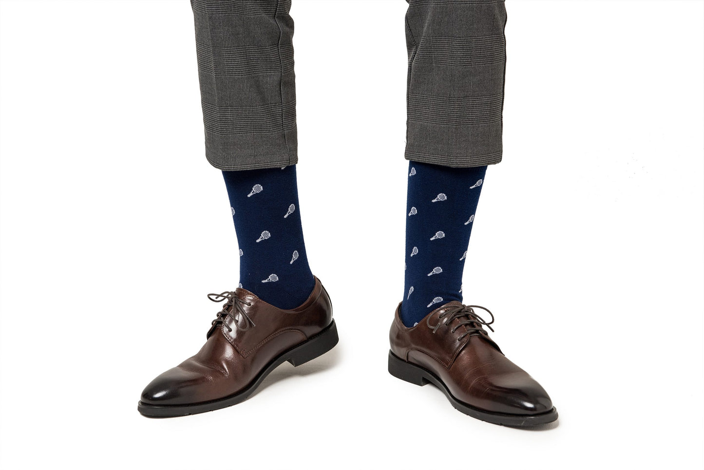 A person wearing gray pants, Tennis Socks, and brown dress shoes showcases a blend of performance and comfort.