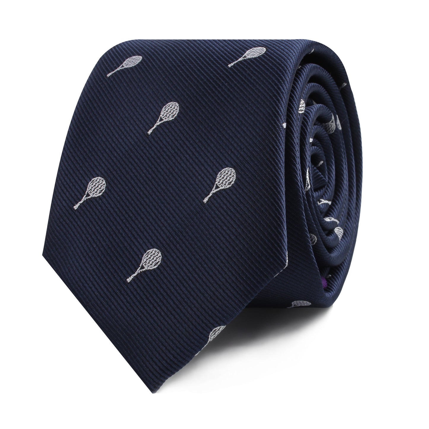 The Tennis Skinny Tie, featuring a rolled-up design in navy blue with small white tennis racket patterns, exudes athletic elegance and timeless refinement.