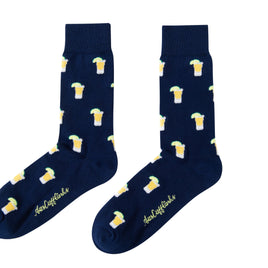 A pair of Tequila socks with a spirited yellow and white toast pattern and white text near the toe area.