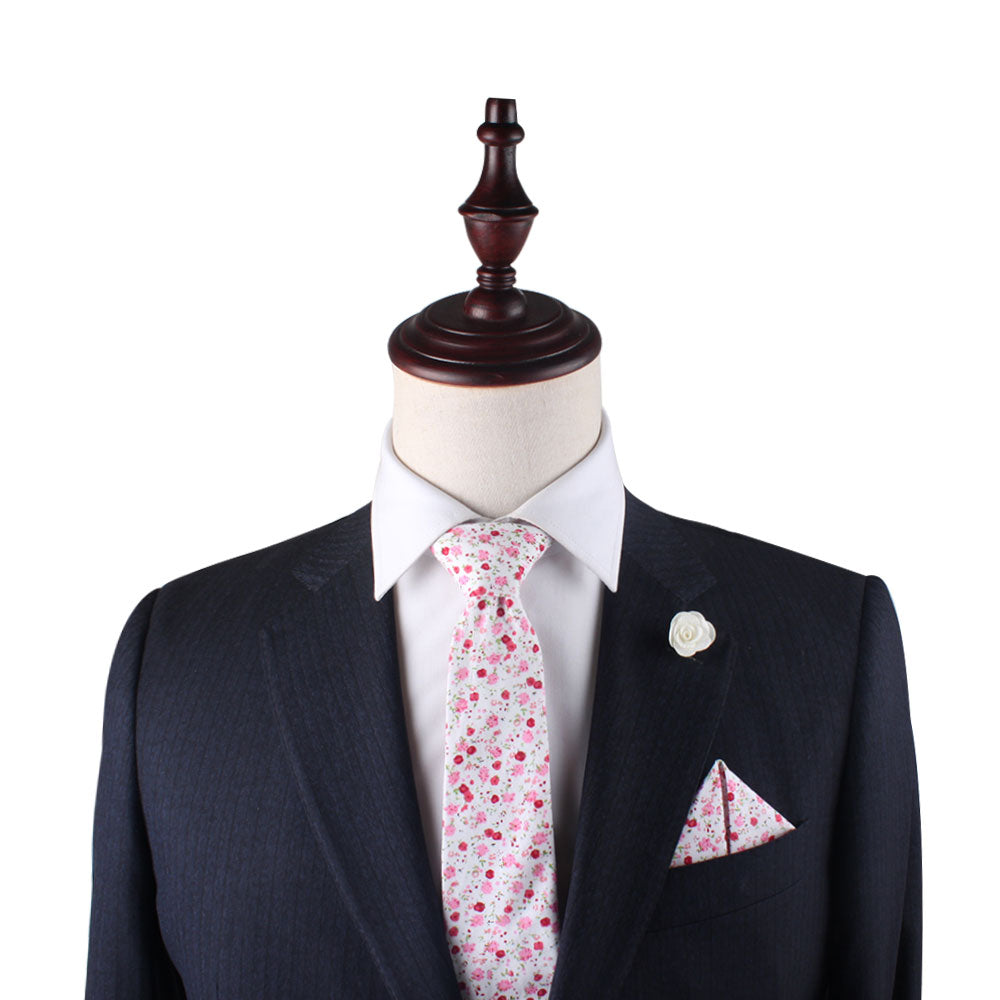 Dapper mannequin displaying a suit with a Tonal Pink Azalea Floral Skinny Cotton tie and matching pocket square.