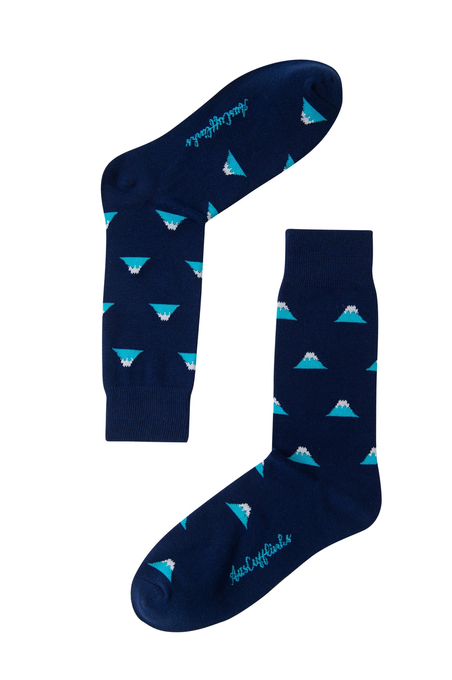 Introducing Mountain Socks – a pair of dark blue socks adorned with a repeating pattern of small, stylized white mountain peaks accented with turquoise details.