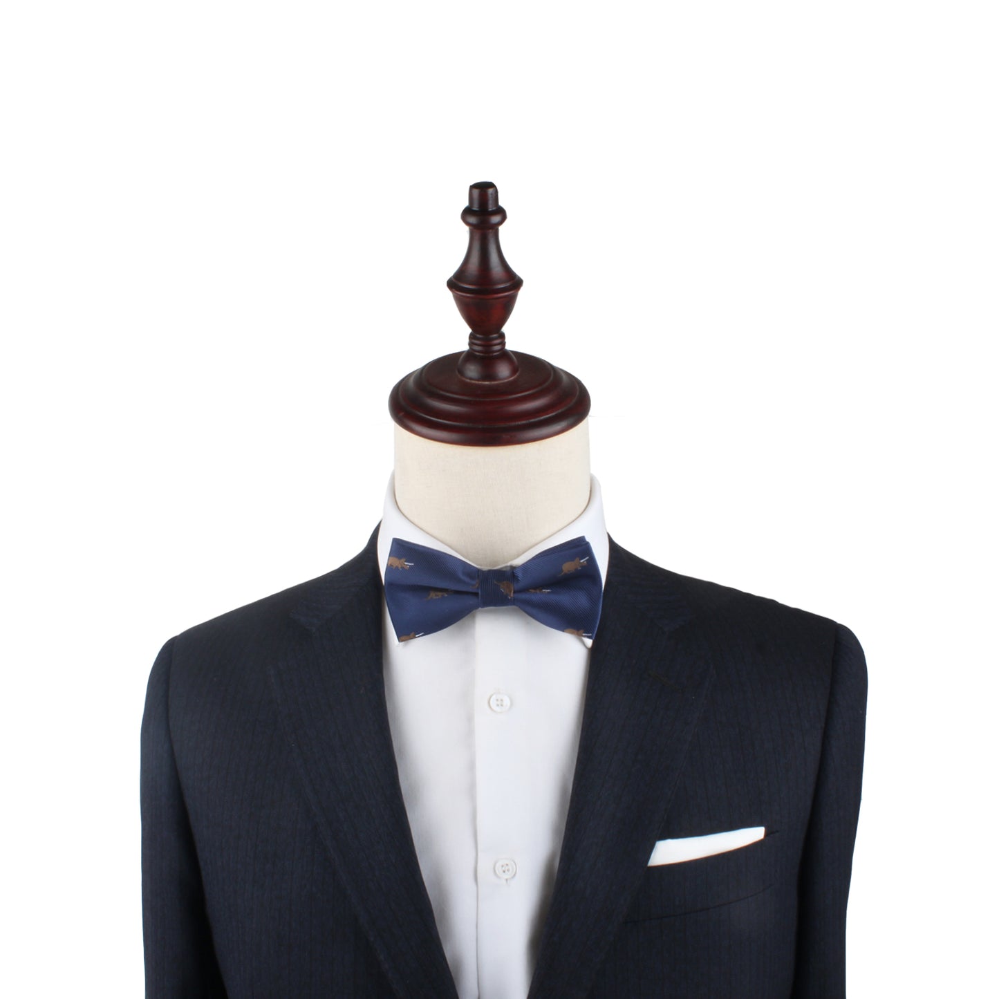 A mannequin sports a tailored dark suit and white shirt, accented by a chic Triceratops Bow Tie, set against a plain white background.