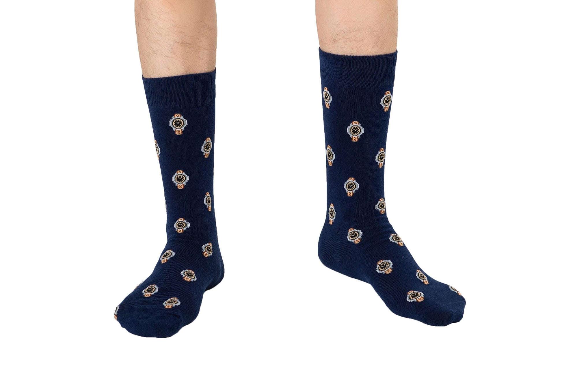 A pair of legs wearing Watch Socks with a timeless decorative pattern of gold and white emblems, isolated on a white background.