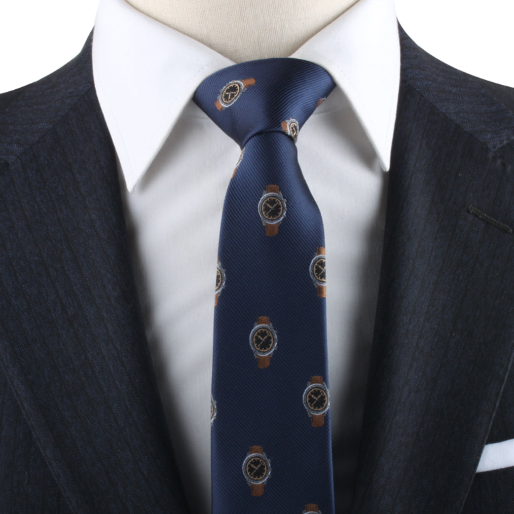 Close-up of a mannequin dressed in a dark suit, white shirt, and a blue Watch Pattern Tie, exuding timeless elegance.