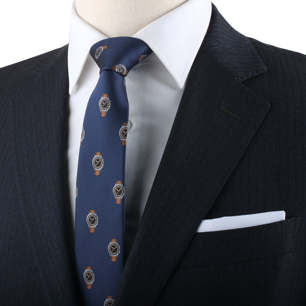 Close-up of a mannequin dressed in a dark suit, white shirt, and Watch Print Tie with circular gold patterns, displaying timeless elegance in formal attire.