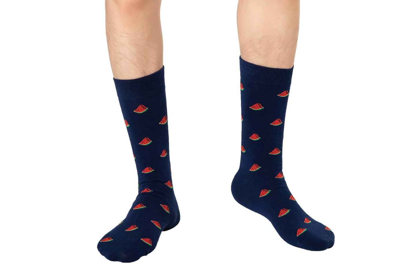 A person wears navy blue Watermelon Socks with a playful watermelon slice pattern, standing on a white background. These breathable socks are a fun, unique gift for any occasion.