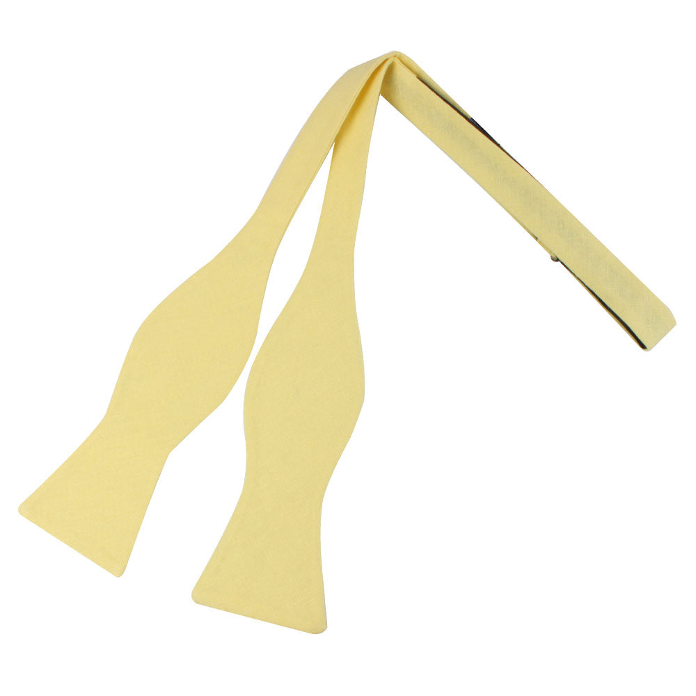 The Yellow Self Tie Bow Tie, made of premium cotton, is laid flat on a white background—ideal for the modern gentleman seeking style and elegance.