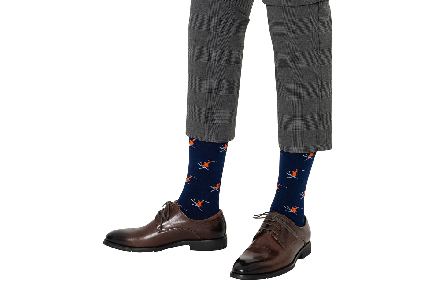 A person wearing grey plaid trousers, brown dress shoes, and Ski Socks.