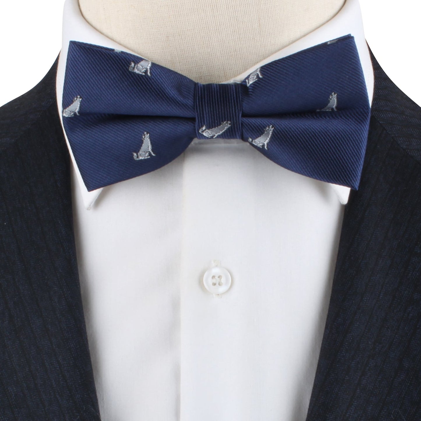 The Wolf Bow Tie, featuring a navy background with a repeating small dog pattern, becomes a statement piece when worn with a dark suit jacket and crisp white dress shirt.