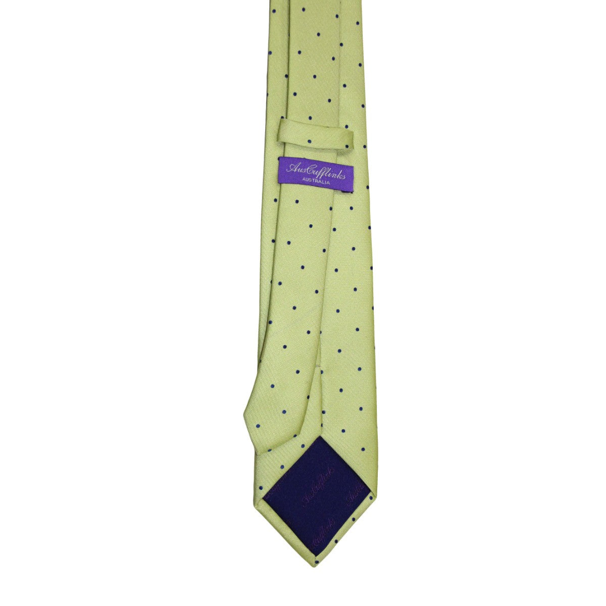 A navy skinny tie featuring gold polka dots adds a youthful charm and an elegant touch.