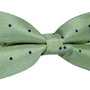 Elevate your style with our Green Navy Polka Dot Bow Tie, showcasing small blue polka dots on a clean white background. Perfectly crafted for formal occasions, it adds a touch of elegance to any look.