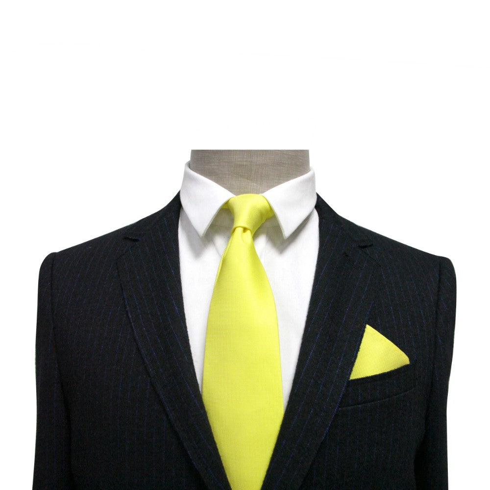A mannequin wearing a dark suit and white shirt displays a vibrant yellow tie and Yellow Pocket Square, ideal for formal occasions, set against a plain backdrop.