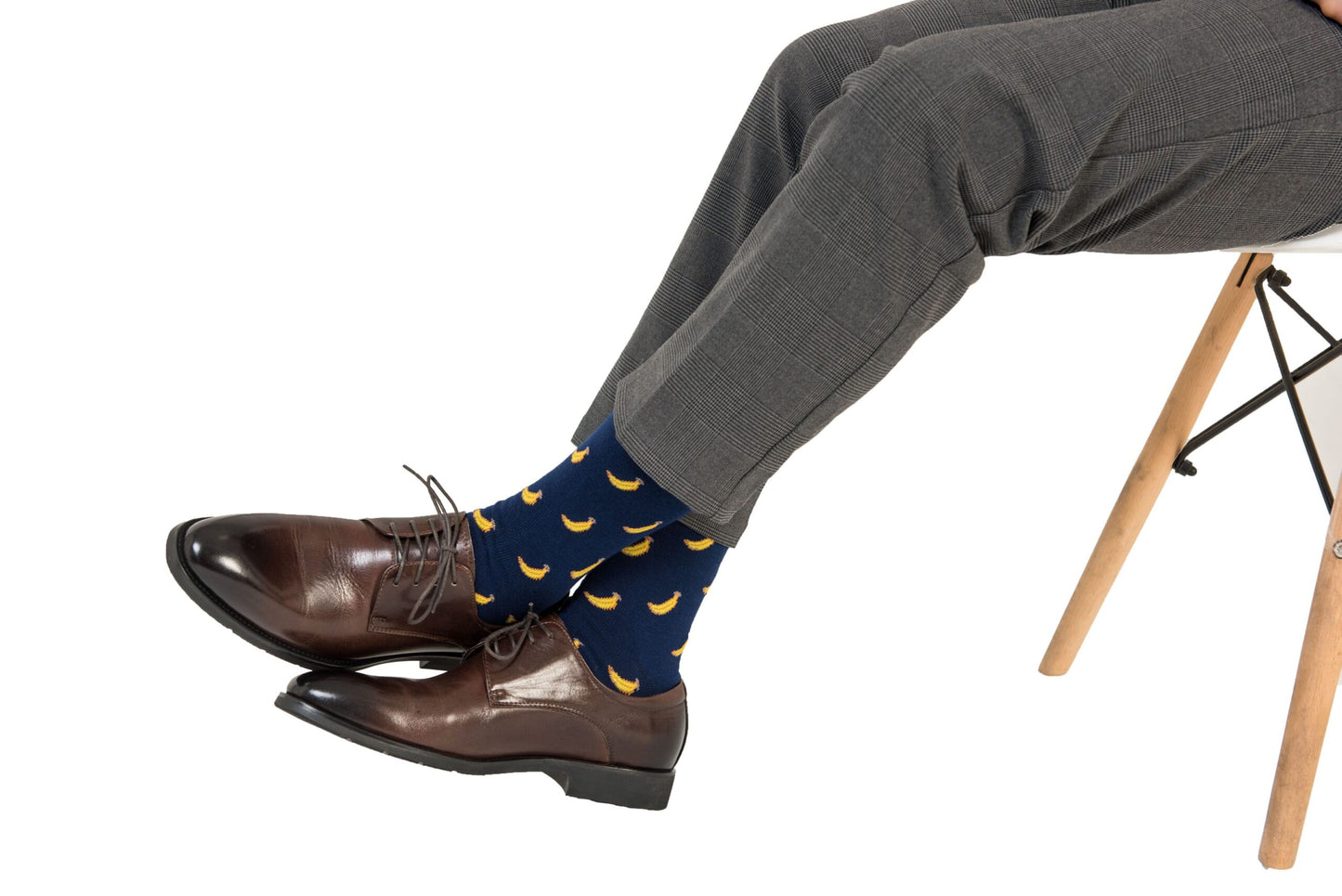 A person's legs with a pair of Banana Socks and shoes.