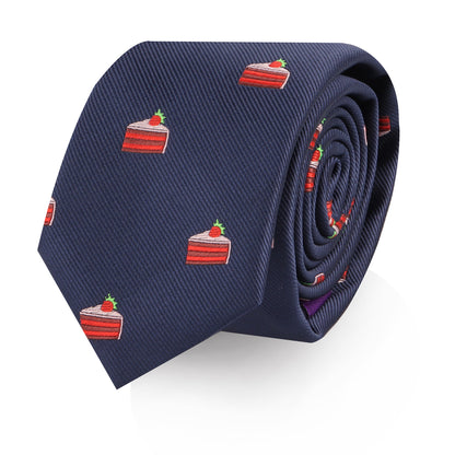 The Strawberry Cake Skinny Tie is a navy blue novelty tie featuring a repeating pattern of red and white cake slices topped with strawberries—ideal for dessert lovers.