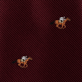 Close-up of the Horse Racing Skinny MAROON Tie, featuring a diagonal ribbed texture and small embroidered horse and jockey motifs—perfect for horse racing enthusiasts and equestrian style.