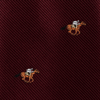 Close-up of the Horse Racing Skinny MAROON Tie, featuring a diagonal ribbed texture and small embroidered horse and jockey motifs—perfect for horse racing enthusiasts and equestrian style.