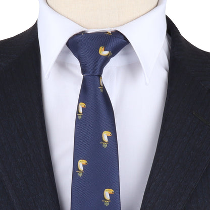 A person wearing a dark pinstripe suit and white dress shirt pairs it with the Toucan Bird Skinny Tie—featuring a blue tropical toucan pattern, making it a unique gift for bird lovers.
