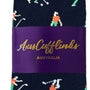 Navy socks named "Angry Golfer Socks" showcase golfers in various poses, adding a sporty flair to your wardrobe, wrapped with a purple band labeled "AusCufflinks Australia.