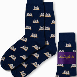 Navy "Book Socks" adorned with an open book pattern, ideal for bibliophiles, come packaged with a label that reads "AusCufflinks Australia." Experience literary luxury with every step.