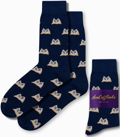 Navy "Book Socks" adorned with an open book pattern, ideal for bibliophiles, come packaged with a label that reads "AusCufflinks Australia." Experience literary luxury with every step.