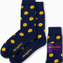 Cookie Socks in a dark blue color showcase a sugary design adorned with yellow polka dots and feature the "AusCufflinks" logo in gold text. Crafted for comfort, the packaging prominently emphasizes their Australian origin.