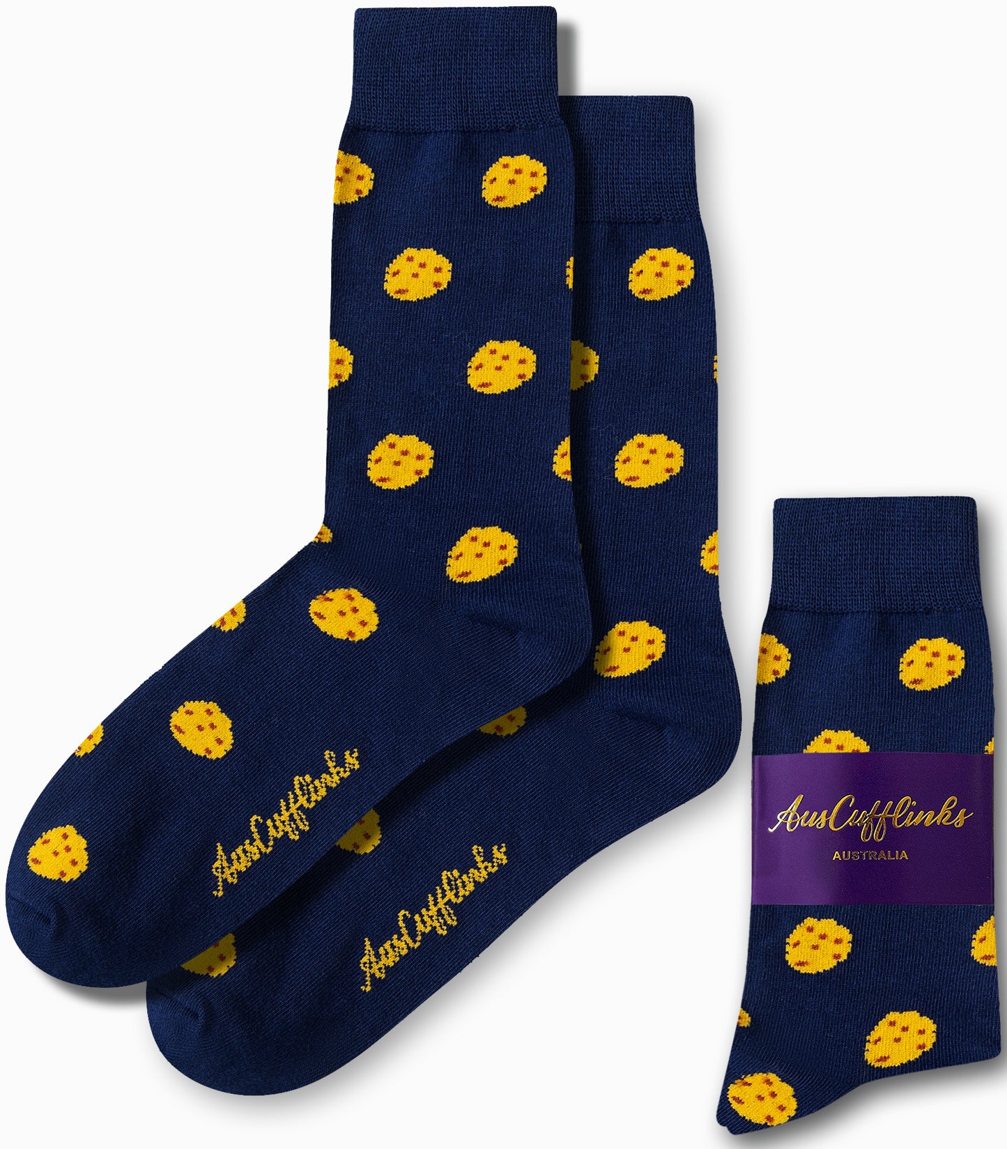 Cookie Socks in a dark blue color showcase a sugary design adorned with yellow polka dots and feature the "AusCufflinks" logo in gold text. Crafted for comfort, the packaging prominently emphasizes their Australian origin.